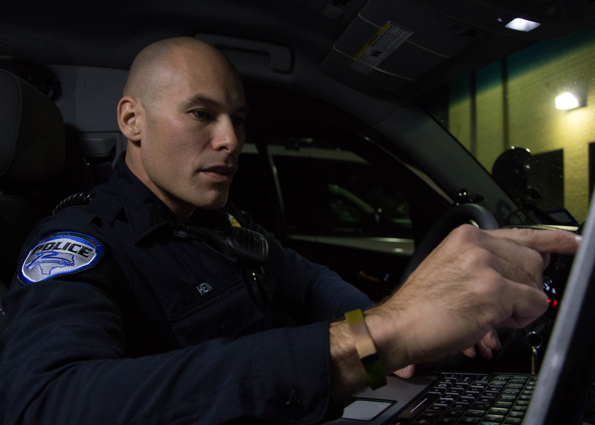 Steven Hein, a police officer with the Richardson Police Department, inspects his vehicle prior to a patrol in Richardson, Texas, Jan. 28, 2016. Hein will be a two-time competitor at the 2016 Best Warrior Competition. (Texas Air National Guard photo by Tech. Sgt. Vanessa Reed/ Released)