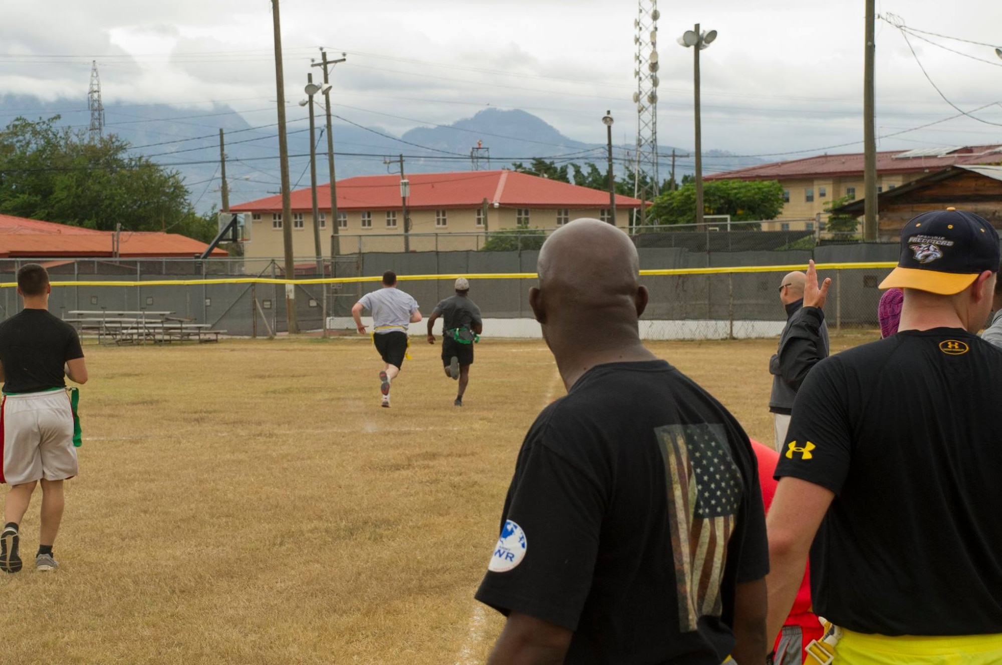 Keith Tandy, Tampa Bay Buccaneers safety, outruns a member of the 612th Air Base Squadron team during a game of flag football with Servicemembers Feb. 6, 2016 at Soto Cano Air Base, Honduras, as a part of a visit to the base hosted by the Armed Forces Entertainment for Super Bowl 50. (U.S. Air Force photo by Capt. Christopher Mesnard/Released)