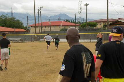 Keith Tandy, Tampa Bay Buccaneers safety, outruns a member of the 612th Air Base Squadron team during a game of flag football with Servicemembers Feb. 6, 2016 at Soto Cano Air Base, Honduras, as a part of a visit to the base hosted by the Armed Forces Entertainment for Super Bowl 50. (U.S. Air Force photo by Capt. Christopher Mesnard/Released)