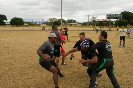 Pictured left, Keith Tandy, Tampa Bay Buccaneers safety, plays a game of flag football with Servicemembers Feb. 6, 2016 at Soto Cano Air Base, Honduras, as a part of a visit to the base hosted by the Armed Forces Entertainment for Super Bowl 50. (U.S. Air Force photo by Capt. Christopher Mesnard/Released)