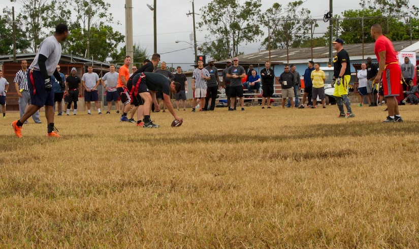 Servicemembers with the Army Forces Battalion and 612th Air Base Squadron at Soto Cano Air Base, Honduras, play a game of flag football Feb. 6, 2016, as a part of a NFL player and cheerleader visit to the base hosted by the Armed Forces Entertainment for Super Bowl 50. (U.S. Air Force photo by Capt. Christopher Mesnard/Released)