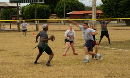 Pictured left, Keith Tandy, Tampa Bay Buccaneers safety, plays a game of flag football with Servicemembers Feb. 6, 2016 at Soto Cano Air Base, Honduras, as a part of a visit to the base hosted by the Armed Forces Entertainment organization for Super Bowl 50. (U.S. Air Force photo by Capt. Christopher Mesnard/Released)