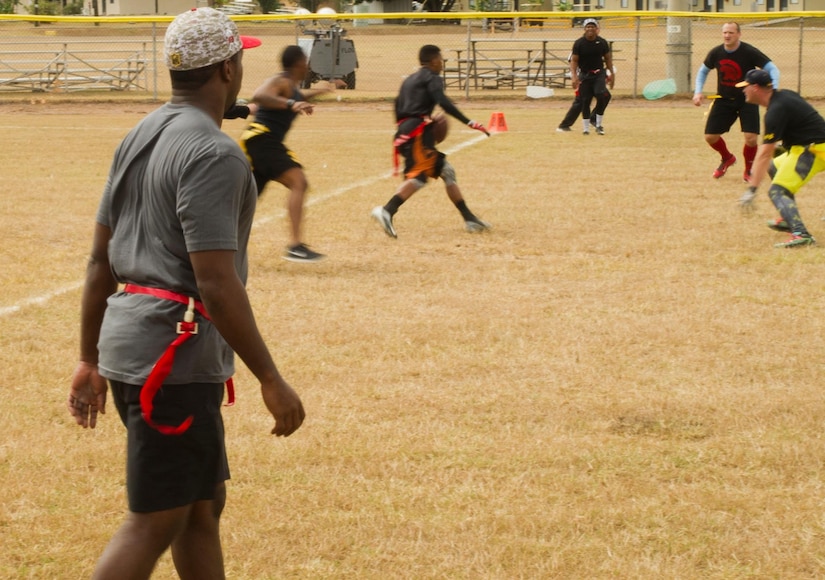 Pictured left, Keith Tandy, Tampa Bay Buccaneers safety, plays a game of flag football with Servicemembers Feb. 6, 2016 at Soto Cano Air Base, Honduras, as a part of a visit to the base hosted by the Armed Forces Entertainment for Super Bowl 50. (U.S. Air Force photo by Capt. Christopher Mesnard/Released)