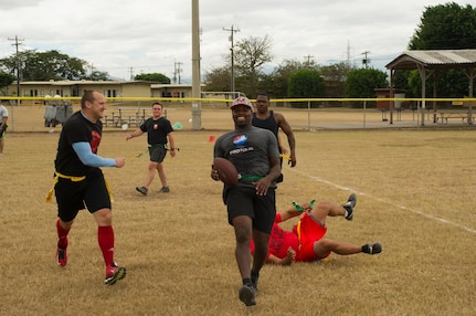 Pictured center, Keith Tandy, Tampa Bay Buccaneers safety, is downed during a game of flag football by a member of the Army Forces Battalion Feb. 6, 2016 at Soto Cano Air Base, Honduras, as a part of a visit to the base hosted by the Armed Forces Entertainment for Super Bowl 50. (U.S. Air Force photo by Capt. Christopher Mesnard/Released)