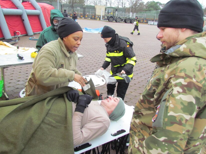 Capt. Shawnda Bass, a Registered Nurse with the 773rd Civil Support Team, evaluated a casualty after a simulated chemical spill during exercise Ocean Response Feb. 11, 2016 at Rhine Ordnance Barracks in Germany. The 773rd trained along with members of the Spanish Unidad Militar de Emergencias and the Slovenian army during the exercise. (Photo by Lt. Col. Jefferson Wolfe, 7th Mission Support Command public affairs office)