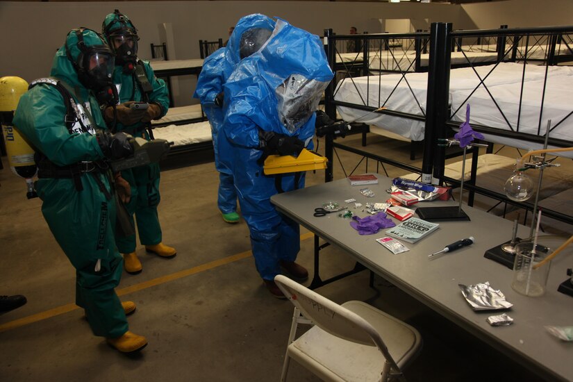 Members of the 773rd Civil Support Team and the Spanish Unidad Militar de Emergencias examine a table simulating production of methamphetamine during exercise Ocean Response Feb.11, 2016 at Rhine Ordnance Barracks in Germany. The 773rd and the UME trained along with members of the Slovenian army during the exercise. (Photo by Lt. Col. Jefferson Wolfe, 7th Mission Support Command public affairs office)