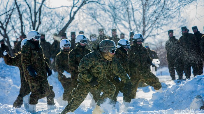 U.S. Marines and Japan Ground Self-Defense Force soldiers use cover to throw snowballs during a snowball fight championship for Forest Light 16-2 in Yausubetsu Training Area, Hokkaido, Japan, Jan. 31, 2016. Forest Light, a semi-annual exercise between the JGSDF and III Marine Expeditionary Force, strengthens military partnership, solidifies regional security agreements and improves individual and unit-level skills. The JGSDF soldiers are with the 27th Infantry Regiment, 5th Brigade, Northern Army. The Marines are with 3rd Battalion, 5th Marine Regiment currently assigned to 4th Marine Regiment, 3rd Marine Division, III MEF through the unit deployment program. 