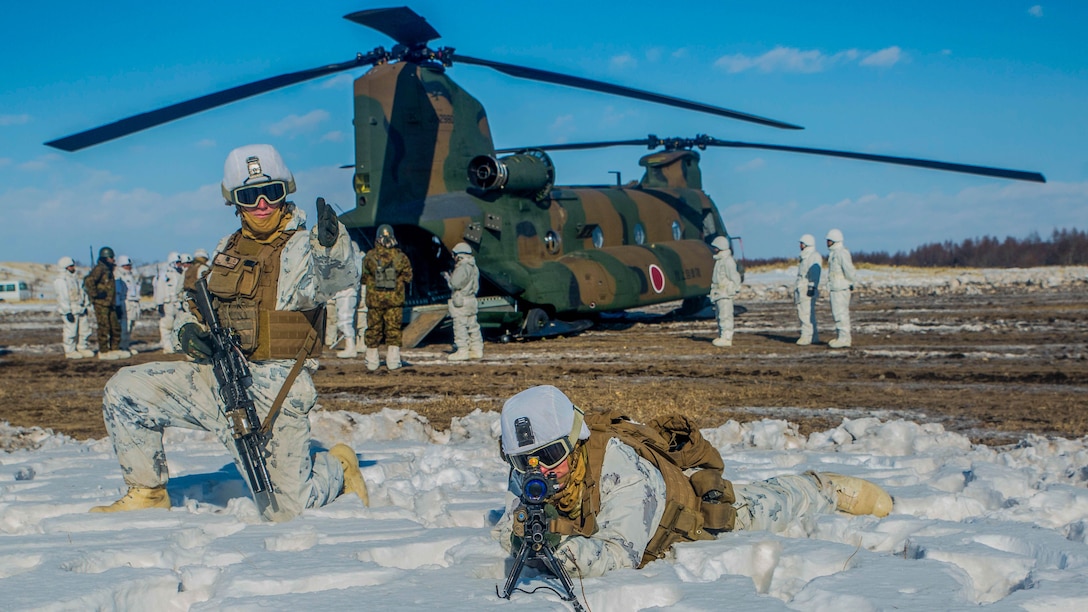 U.S. Marines provide security for a Japan Ground Self Defense Force CH-47 Chinook during Forest Light 16-2 in Yausubetsu Training Area, Hokkaido, Japan, Feb. 1, 2016. The exercise strengthens military partnership, solidifies regional security agreements and improves individual and unit-level skills. The JGSDF soldiers are with the 103 Helicopter Brigade, Northern Army. The Marines are with Kilo Company, 3rd Battalion, 5th Marine Regiment currently assigned to 4th Marine Regiment, 3rd Marine Division, III Marine Expeditionary Force. 