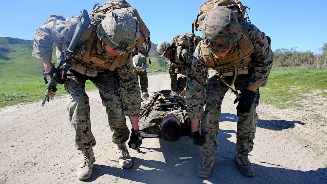 Marines evacuate a simulated casualty during a combat endurance challenge Marine Corps Base Camp Pendleton, Calif.Feb. 5, 2016. The challenge consisted of hiking nearly seven miles, testing weapons systems, combat lifesaving skills, land navigation and simulated casualty evacuation. The Marines with Battery Q, 5th Battalion, 11th Marine Regiment conducted the training aboard MCB Camp Pendleton. 