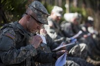 Sgt. Jordan Lepley, a U.S. Army Reserve military police Soldier with the 317th Military Police Battalion, of New Cumberland, Pa., grabs his protractor and notecard from his mouth at the start of a land navigation course in this year's 200th Military Police Command's Best Warrior Competition held at Camp Blanding, Fla., Feb. 9. The winning noncommissioned officer and junior enlisted Soldiers will move on to the U.S. Army Reserve Command competition in May. (U.S. Army photo by Master Sgt. Michel Sauret)