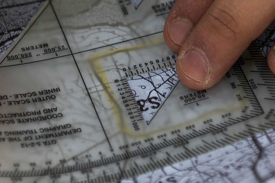 A U.S. Army Reserve miilitary police Soldier plots a grid coordinate on a map during a land navigation course in this year's 200th Military Police Command's Best Warrior Competition held at Camp Blanding, Fla., Feb. 9. The winning noncommissioned officer and junior enlisted Soldiers will move on to the U.S. Army Reserve Command competition in May. (U.S. Army photo by Master Sgt. Michel Sauret)