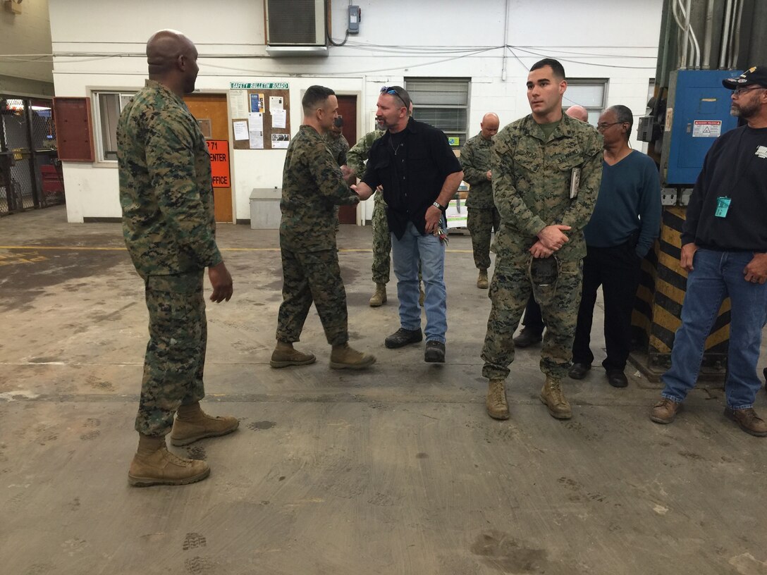 Col. Joseph Murray, base commander, personally shakes the hand of David Payne.