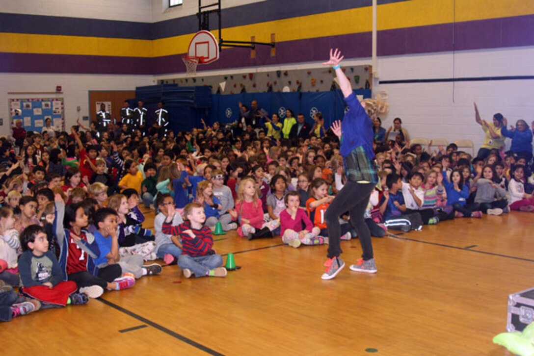 MARINE CORPS BASE QUANTICO, Va. — The school won a performance by Jump with Jill, a rock and roll nutrition show that teaches and celebrates healthy habits through music and dance. Jill (Hailey McDonell) performs for Claremont Elementary students Feb. 5.