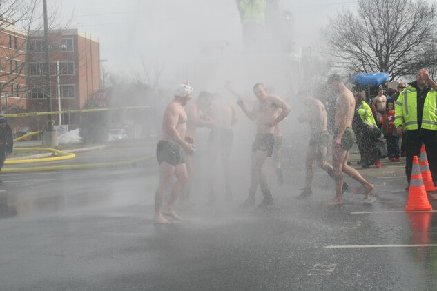 Active duty Marines experience the freezing water of the 2016 Polar Bear Blast, which raised funds for the EOD Warrior Foundation, at James Monroe High School Feb. 6.