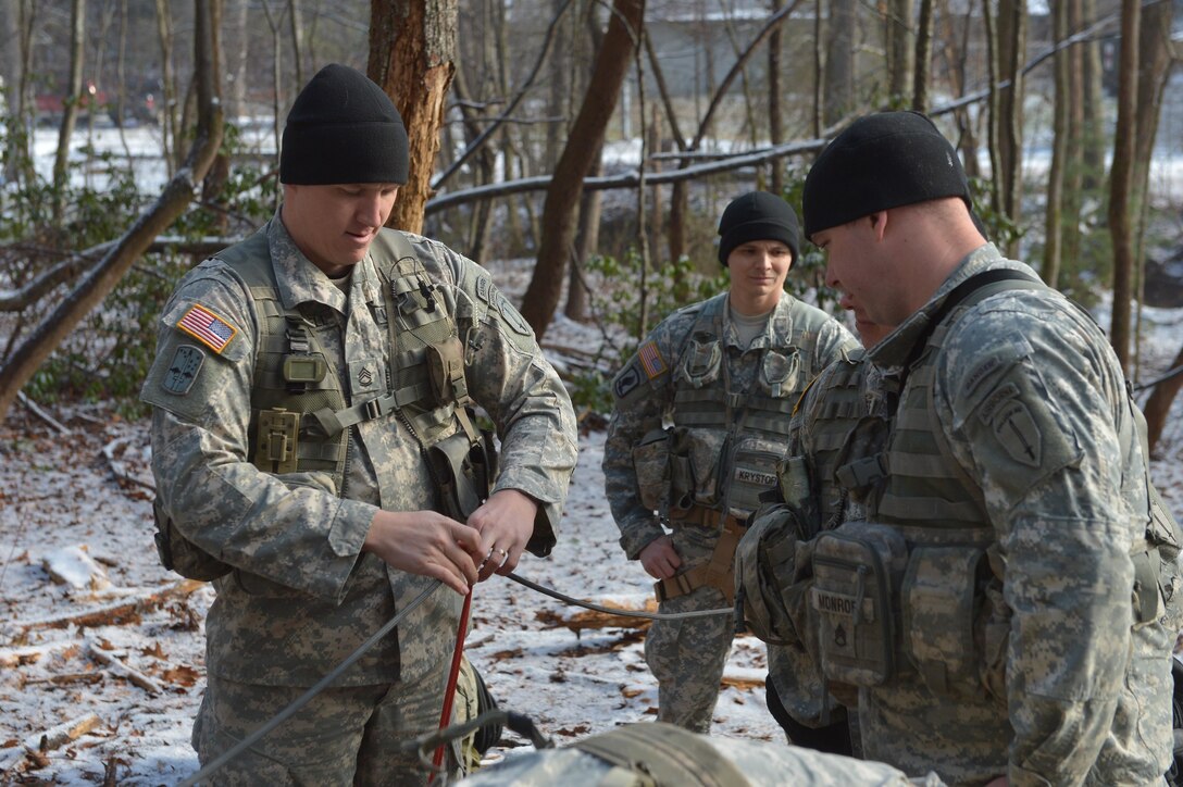 U.S. Army Sgt. 1st Class Shane Frackell, a military mountaineering instructor assigned to 5th Ranger Training Battalion, demonstrates building a rope system to students during the Basic Military Mountaineering Course at Camp Frank D. Merrill, Dahlonega, Ga., Jan. 21, 2016. The Basic Military Mountaineering Course trains Soldiers in the fundamental knowledge/skills required to successfully conduct small unit operations in mountainous terrain found throughout the world. (U.S. Army photo by Staff Sgt. Alex Manne/Released)