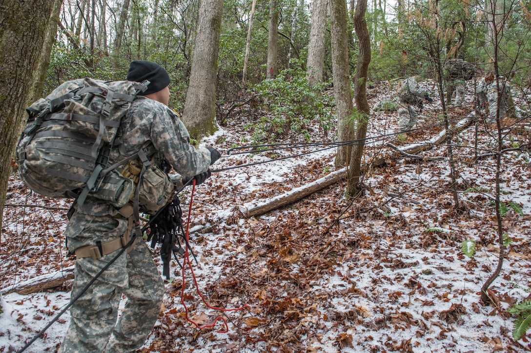 U.S. Army Staff Sgt. Vincent Lavigne, assigned to 5th Ranger Training Battalion, holds a rope in preparation of hoisting a littered patient up a mountain slope during the Basic Military Mountaineering Course at Camp Frank D. Merrill, Dahlonega, Ga., Jan. 21, 2016. The Basic Military Mountaineering Course trains Soldiers in the fundamental knowledge/skills required to successfully conduct small unit operations in mountainous terrain found throughout the world. (U.S. Army photo by Staff Sgt. Alex Manne/Released)