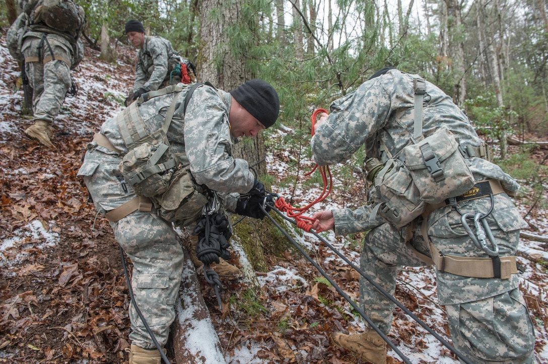 A U.S. Army soldier assigned to 5th Ranger Training Battalion build a rope system in prepartion of hoisting a littered patient up a mountain slope during the Basic Military Mountaineering Course at Camp Frank D. Merrill, Dahlonega, Ga., Jan. 21, 2016. The Basic Military Mountaineering Course trains Soldiers in the fundamental knowledge/skills required to successfully conduct small unit operations in mountainous terrain found throughout the world. (U.S. Army photo by Staff Sgt. Alex Manne/Released)