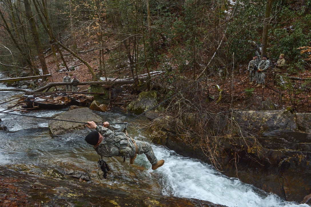 US Army Soldier crosses rope bridge