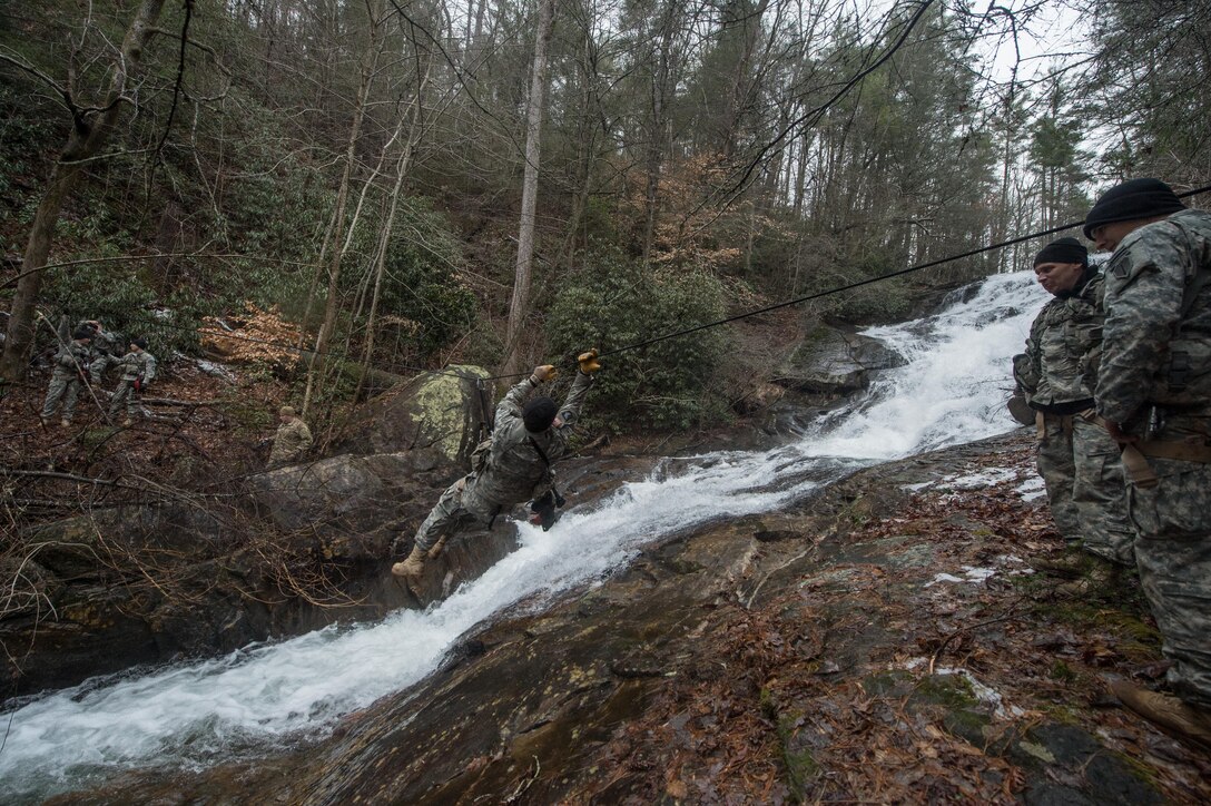 A U.S. Army Soldier assigned to 5th Ranger Training Battalion crosses a rope bridge over the Etowah River during the Basic Military Mountaineering Course at Camp Frank D. Merrill, Dahlonega, Ga., Jan. 21, 2016. The rope bridge is a "tight rope” or high load installation used to move personnel and equipment over terrain obstacles such as swift flowing mountain streams, ravines, and other deep gullies. (U.S. Army photo by Staff Sgt. Alex Manne/Released)