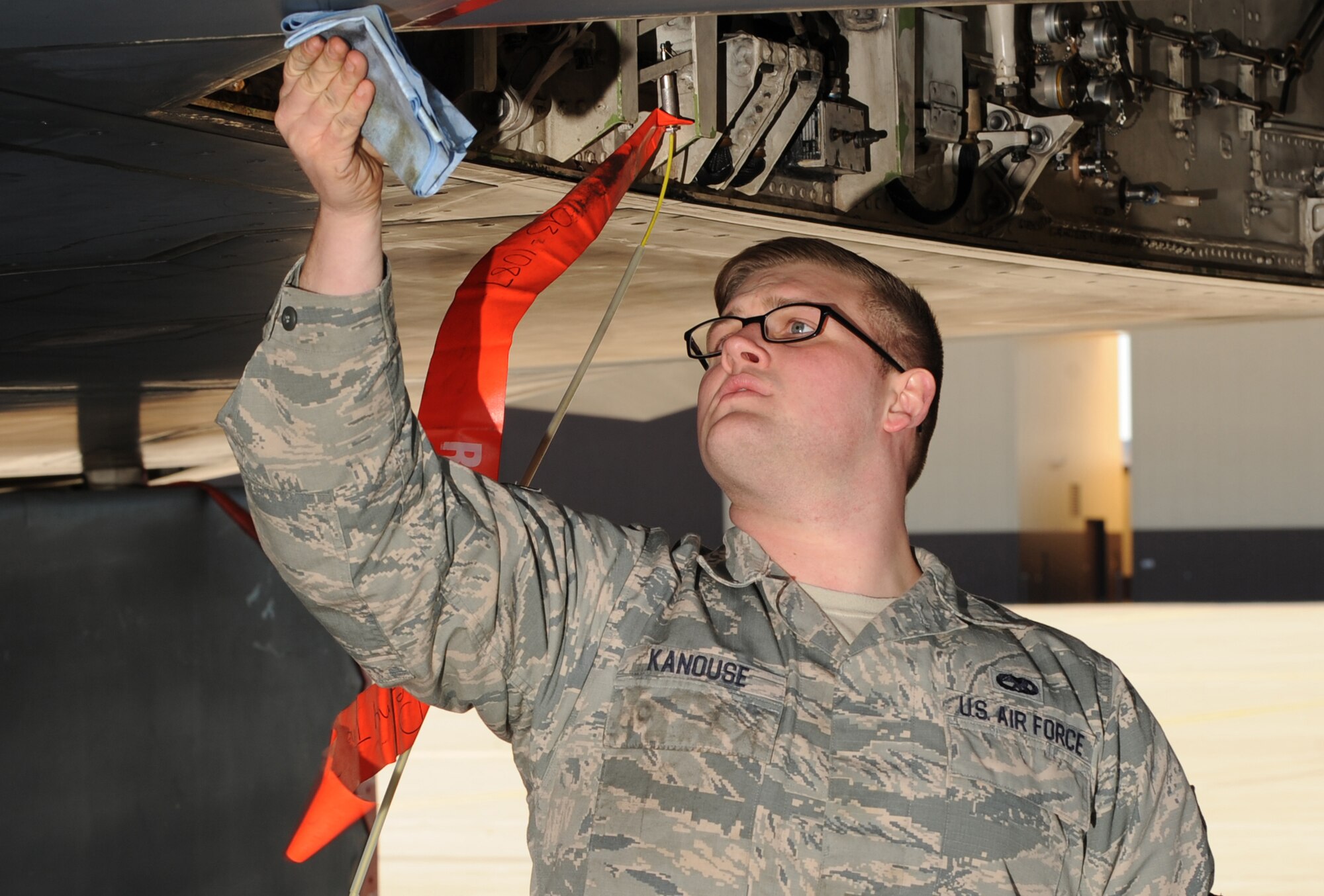 U.S. Air Force Senior Airman Zachary Kanouse, a 509th Aircraft Maintenance Squadron dedicated crew chief, wipes down a panel on a B-2 Spirit during a quick-turn inspection at Whiteman Air Force Base, Mo., Feb. 2, 2016. Kanouse checked components on the aircraft such as the oil and hydraulic brake lines prior to the aircraft taking off for an evening mission during Red Flag (RF) 16-1 exercise. RF involves a variety of attack, fighter, bomber, reconnaissance, electronic warfare, airlift support and search and rescue aircraft. (U.S. Air Force photo by Tech. Sgt. Miguel Lara III)