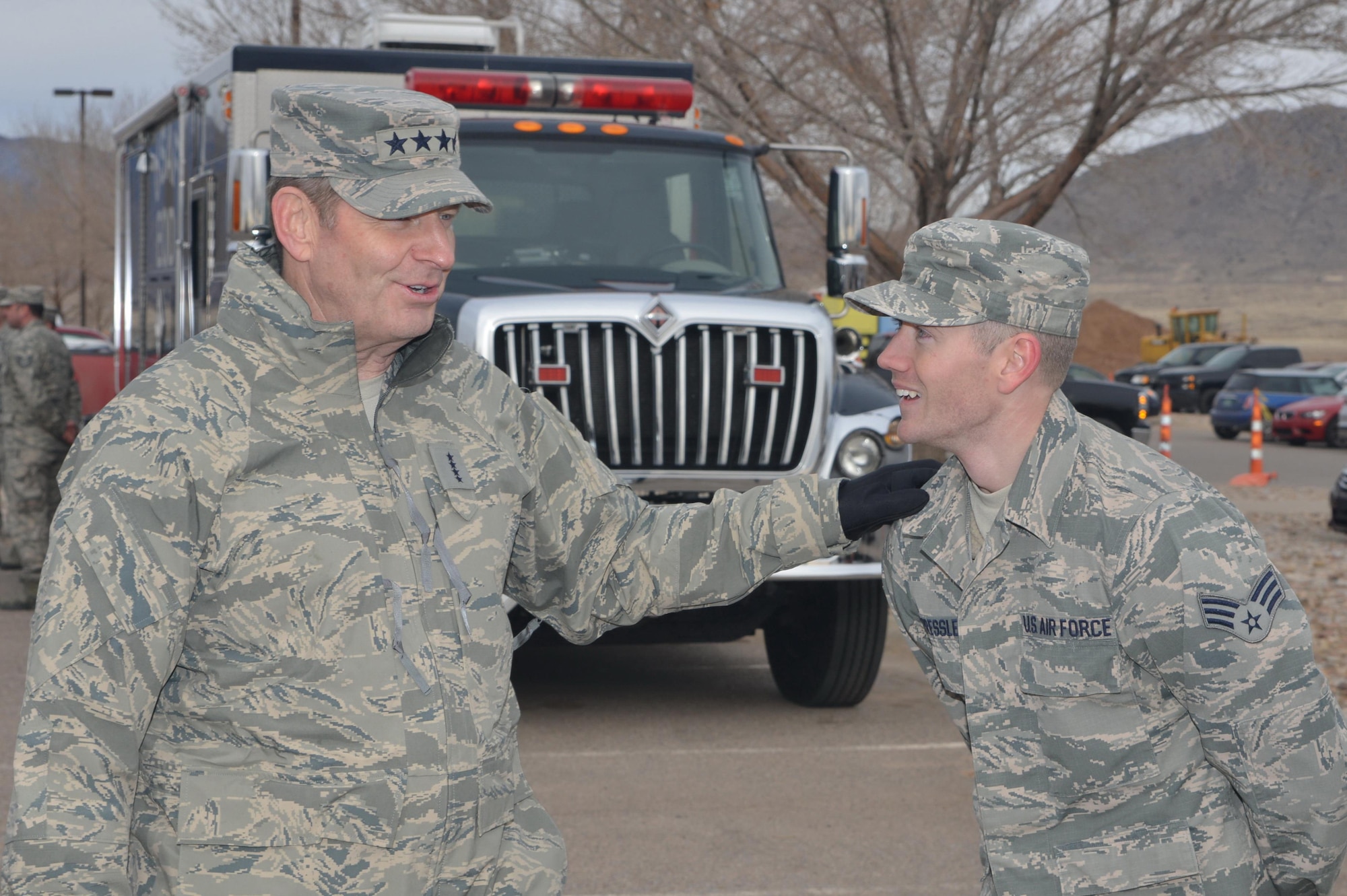 Gen. Robin Rand, Air Force Global Strike Command commander, shares a laugh with Senior Airman Joshua Pressley, a technician in the 377th Aerospace Medicine Squadron, during a visit to Kirtland Air Force Base Feb. 4.  Pressley and his co-workers briefed the general on the squadron's bioenvironmental engineering capabilities and gave an equipment demonstration. 