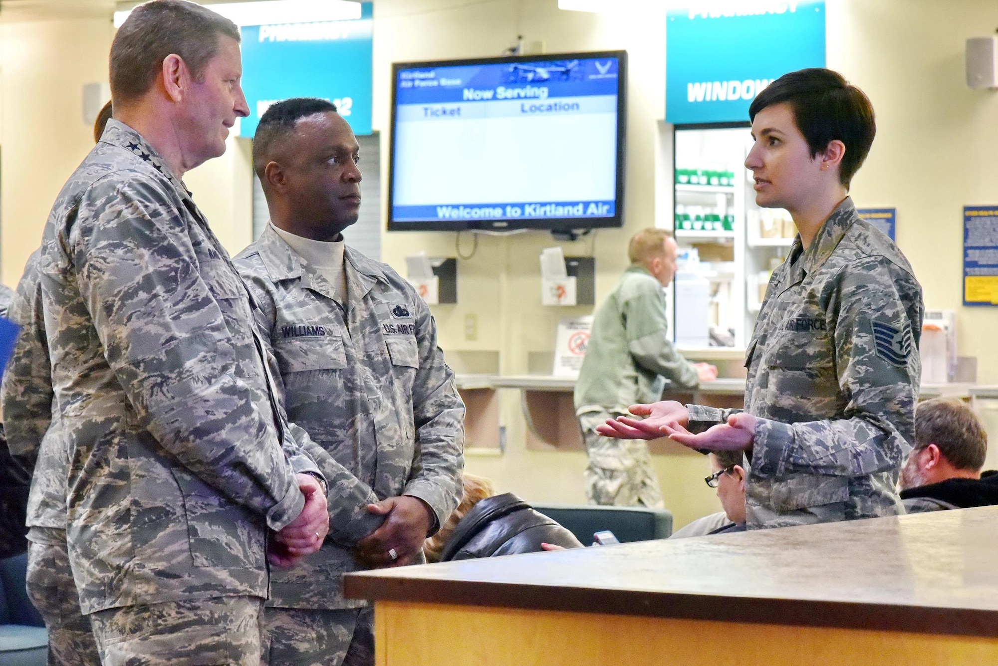 Gen. Robin Rand, Air Force Global Strike Command commander, and Chief Master Sgt. Calvin Williams, AFGSC command chief, visit with Tech. Sgt. Raechael Evans, a pharmacy technician in the 377th Medical Support Squadron, during a visit to Kirtland Feb. 4. Evans briefed several pharmacy successes, such as the implementation of electronic prescribing and the opening a new pharmacy at the Base Exchange. 