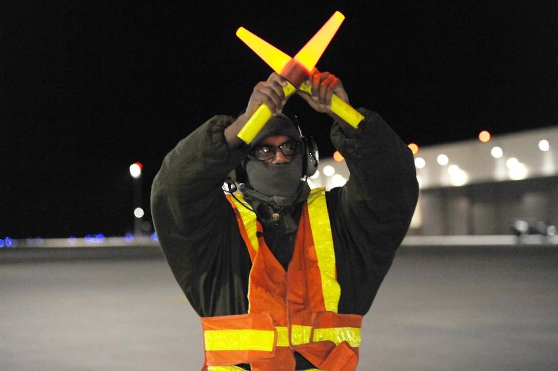 U.S. Air Force Senior Airman Detroy Brooks, a 509th Aircraft Maintenance Squadron crew chief, marshals a B-2 Spirit aircraft at Whiteman Air Force Base, Mo., Feb. 2, 2016. Crew chiefs play a vital role in ensuring traffic safety on the flightline while aircraft taxi before takeoff.