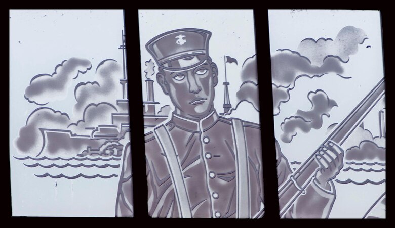 The central figure portrays a Marine, in a uniform during the time period of the war with Spain. The background depicts the Morro Castle as it appears on the Spanish American War Campaign Medal.