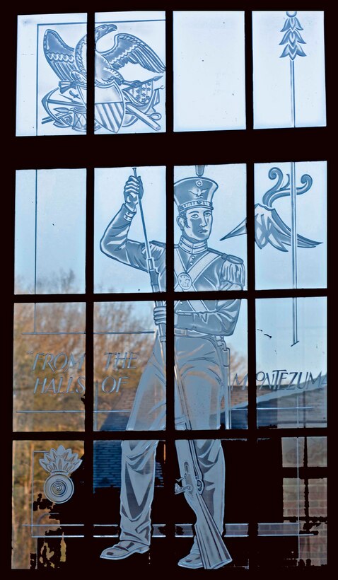 The war between Mexico and the U.S. is the main theme of this window. From Chapulte-pec, Mexico City and the Halls of Montezuma could be seen. To the left of the central figure is a bursting bomb, an ornament worn on the coattails of the officer’s uniforms at the time of the Mexican war and later adopted in 1916 as a symbol of rank for Marine gunners.