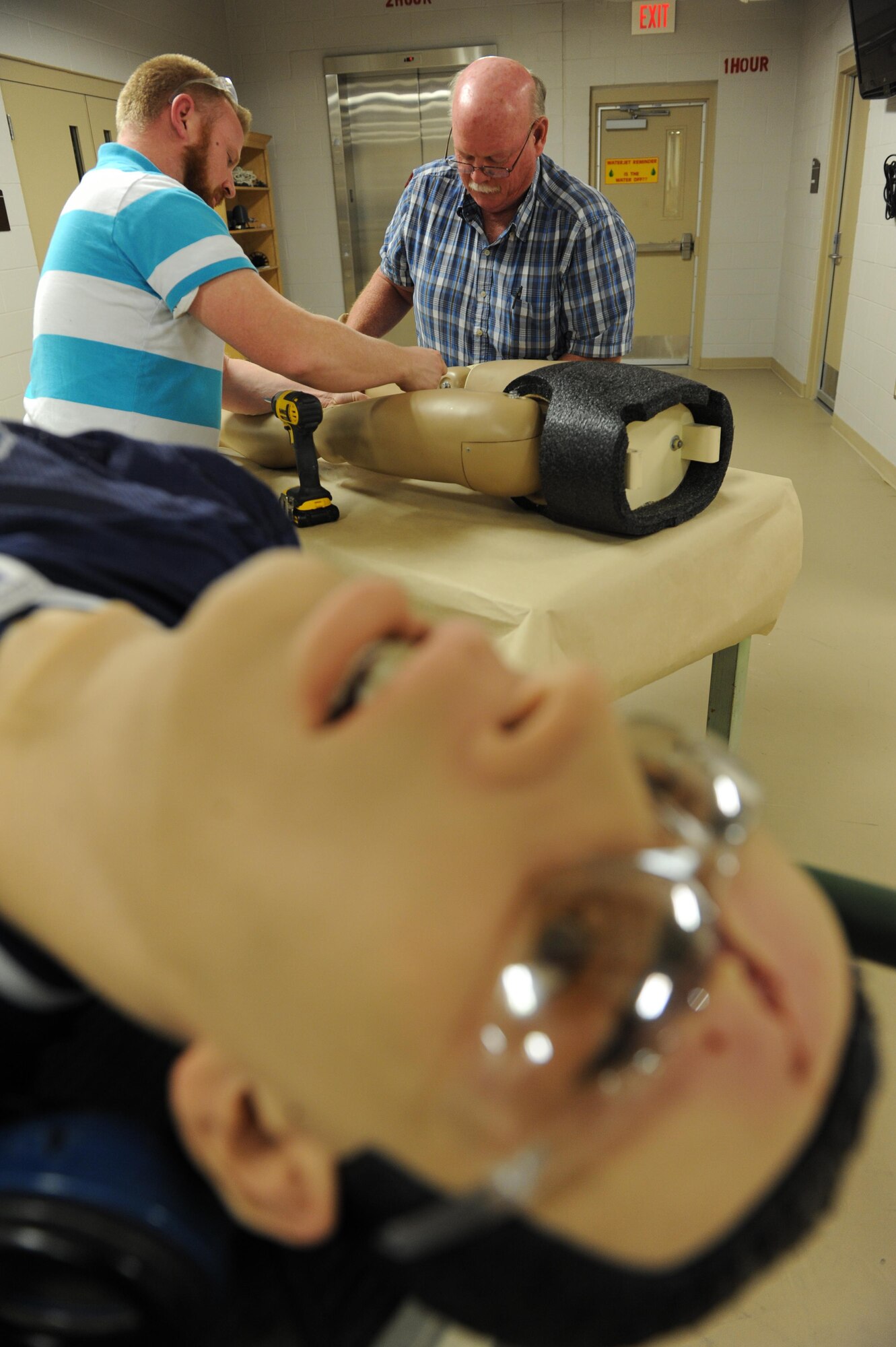 James McCanless, 81st Training Support Squadron sheet metal technician, and Tom Capers, 81st TRSS machinist and welder, assemble mannequin pieces at the Trainer Development Center Feb. 8, 2016, Keesler Air Force Base, Miss. The 81st TRSS manufactured two lower torso mannequins for the 81st Medical Group to be used for training. By manufacturing the training mannequin in-house, the 81st TRSS saved the Air Force an estimated $21,000. (U.S. Air Force photo by Kemberly Groue)