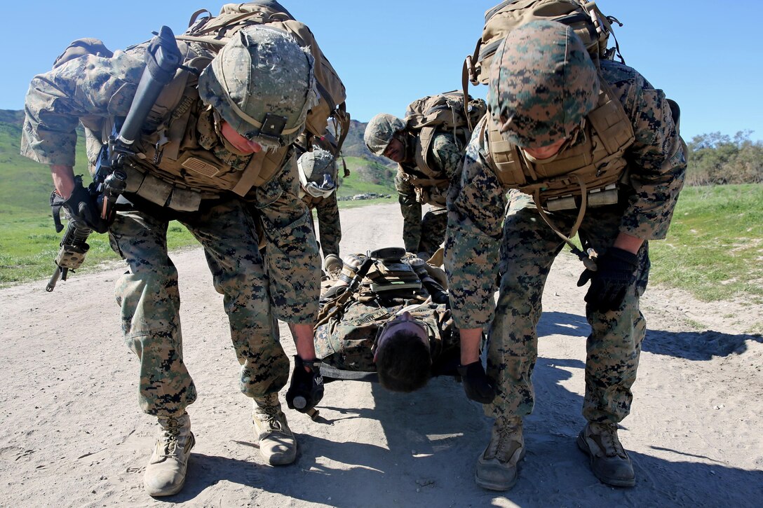 Marines evacuate a simulated casualty during combat endurance challenge on Marine Corp Base Camp Pendleton, Feb. 5, 2016. Marines hiked nearly seven miles, testing weapons systems, combat lifesaving skills, land navigation and simulated casualty evacuation. Marine Corps photo by Pvt. Robert Bliss