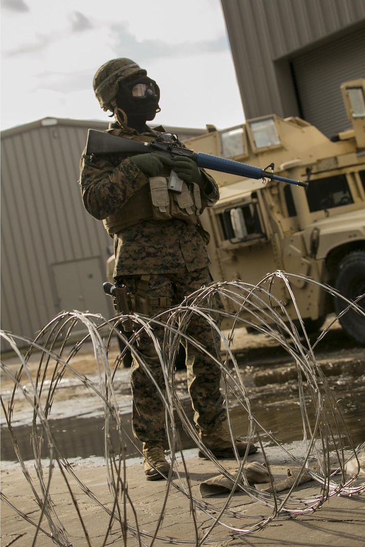 Cpl. Jake Korb, a policeman with 2nd Law Enforcement Battalion, stands guard at the front gate of the forward operating base at Camp Lejeune, N.C., Feb. 9, 2016. During the time the Marines spent in the field, they encountered multiple obstacles, and confronted different scenarios in preparation for an upcoming deployment with the 24th Marine Expeditionary Unit. The obstacles that they faced included rugged environments, improvised explosive devices and ambushes by the enemy. (U.S. Marine Corps photo by Lance Cpl. Luke Hoogendam/Released)
