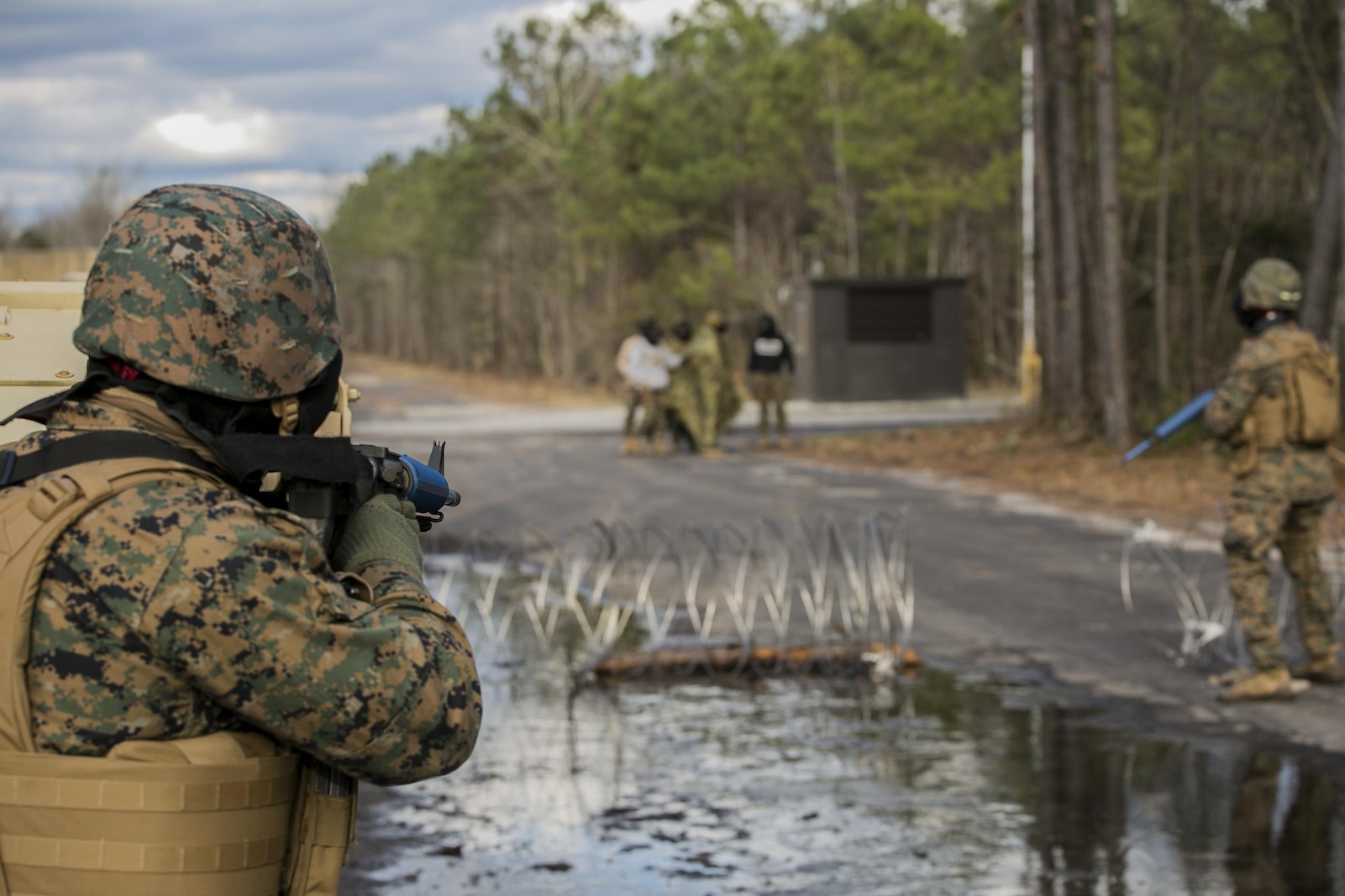 Marines with 2nd Law Enforcement Battalion confront -rock-throwing hostiles at Camp Lejeune, N.C., Feb. 9, 2016. This kind of training allows 2nd LEB to develop and practice all the capabilities that the unit brings to the Marine Expeditionary Unit. The obstacles that they faced included rugged environments, improvised explosive devices and ambushes by the enemy. (U.S. Marine Corps photo by Lance Cpl. Luke Hoogendam/Released)