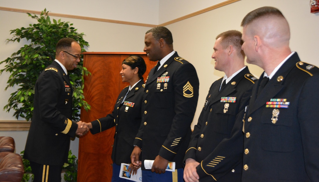 Maj. Gen. A.C. Roper, commander 80th Training Command, presents Sgt. 1st Class Katre Nicholson, Equal Opportunity Advisor, 4th Brigade, 94th Training Division, with his commander’s coin while congratulating her for graduating the Equal Opportunity Advisors Reserve Component Course. Roper presented the coin to Nicholson and three other Army Reserve Soldiers from across the 80th TC after delivering the keynote address during the graduation ceremony at the Defense Equal Opportunity Management Institute Patrick Air Force Base, Fla., Feb. 5, 2016. The other three Soldiers from L-R Sgt 1st Class Richard Cobbs, 2nd Brigade 100th Training Division, Sgt 1st Class Norman Wade, 1st Brigade 102nd Training Division, and Master Sgt. Jerry Burton, Headquarters, Headquarters Company 100th Training Division.