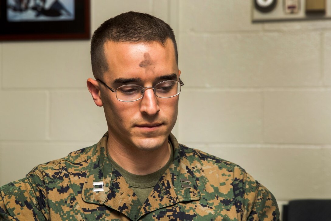 Captain Christopher Karle listens to a religious passage during an Ash Wednesday service, Feb. 10, 2016. During the service, those in attendance were marked with ash on their forehead. The ash symbolizes confession, repentance and penance. The observance commences the Lenten season in the liturgical calendar. The service was given by Cmdr. James Johnson, Navy chaplain, with I Marine Headquarters Group, I Marine Expeditionary Force, and was held at Camp Pendleton. Karle is the logistics officer for I MHG, I MEF. (U.S. Marine Corps photo by Sgt. Emmanuel Ramos/Released)