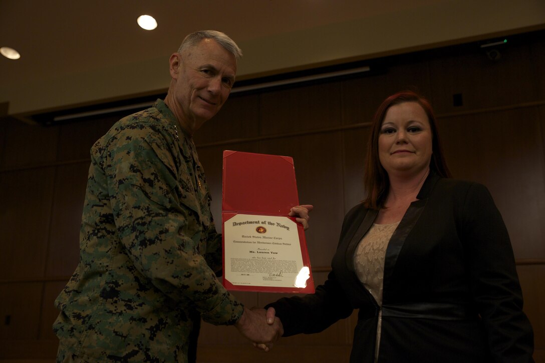 Lt. Gen. Rex C. McMillian, commander of Marine Forces Reserve presents Lauren C. Yaw, muster program lead for Marine Corps Individual Reserve Support Activity, a certificate after being named the Marine Forces Reserve 2015 junior Civilian of the Year, Feb. 5, 2016, at Marine Corps Support Facility New Orleans. Yaw went above and beyond her everyday job duties, and was recognized for her hard work. (U.S. Marine Corps Photo by Lance Cpl. Melissa Martens/ Released)