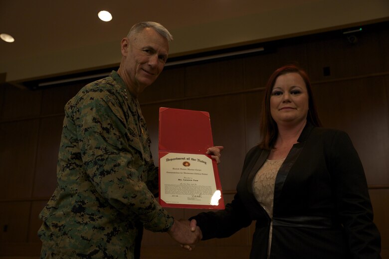 Lt. Gen. Rex C. McMillian, commander of Marine Forces Reserve presents Lauren C. Yaw, muster program lead for Marine Corps Individual Reserve Support Activity, a certificate after being named the Marine Forces Reserve 2015 junior Civilian of the Year, Feb. 5, 2016, at Marine Corps Support Facility New Orleans. Yaw went above and beyond her everyday job duties, and was recognized for her hard work. (U.S. Marine Corps Photo by Lance Cpl. Melissa Martens/ Released)