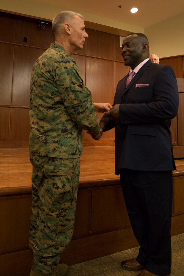 Lt. Gen. Rex C. McMillian, commander of Marine Forces Reserve, presents Anthony T. Davis, deputy branch head of Training and Readiness Division, Marine Forces Reserve, with the senior Civilian of the Year award, Feb. 5, 2016, at Marine Corps Support Facility New Orleans. Davis stood out to his leadership for his continuous efforts to achieve mission accomplishment in the workplace. (U.S. Marine Corps photo by Lance Cpl. Melissa Martens/ Released)
