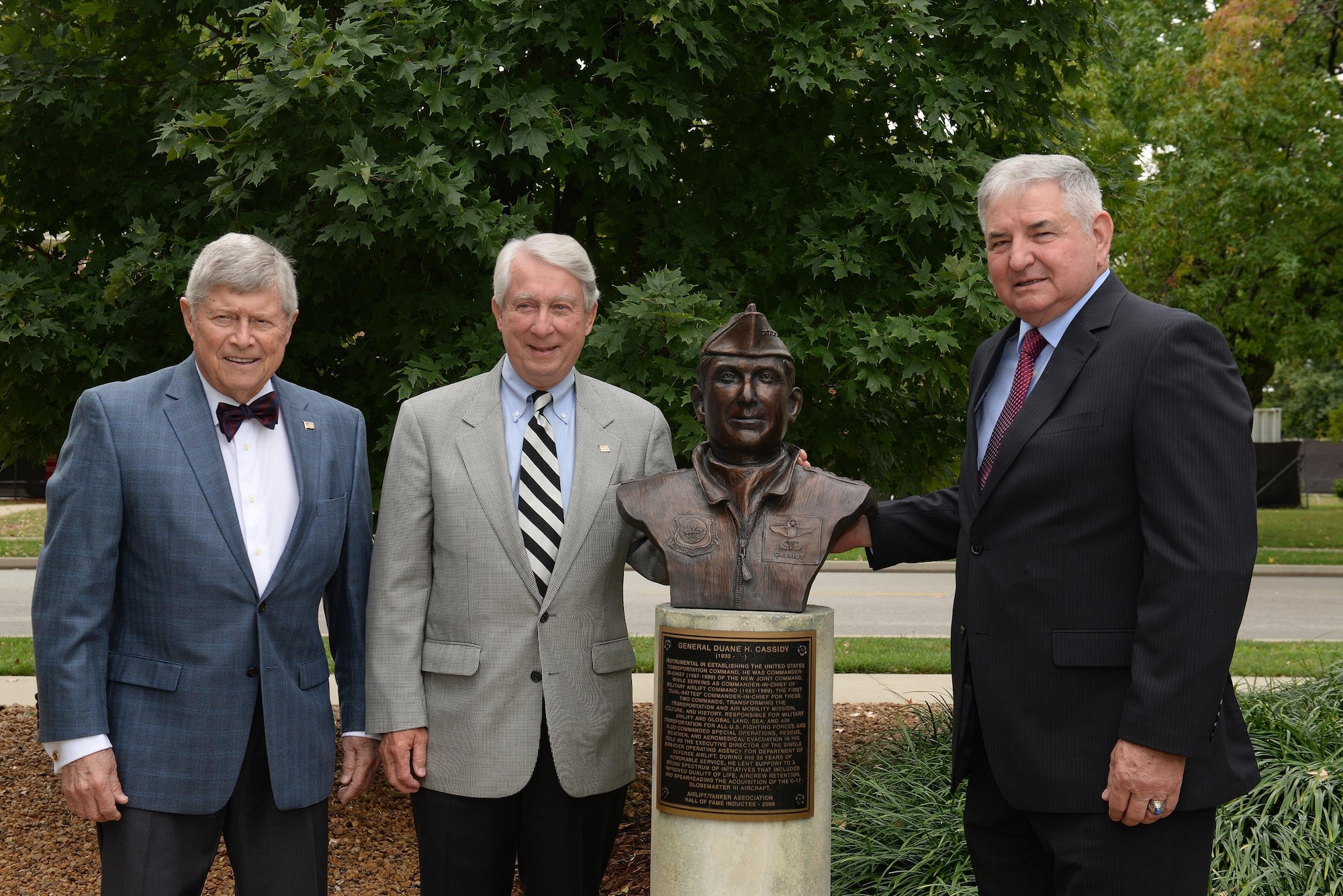 Retired Gen. Duane H. Cassidy, center, stands in front of his newly unveiled bust into the Airlift/Tanker Association's Walk of Fame during a ceremony Oct. 9, 2014, at Scott Air Force Base, Ill. (U.S. Air Force photo/Senior Airman Tristin English) 