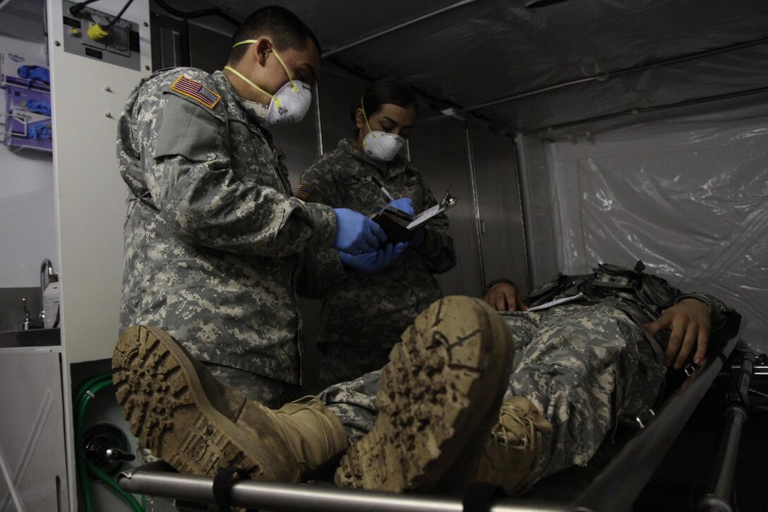 U.S. Army Spc. Luis Torres and Spc. Jazmin Martinez, mortuary affairs specialists assigned to the 387th Quartermaster Company, record the content in Pvt. Victor Gonzalez’s wallet for the Warrior Exercise (WAREX) 78-16-01 at Contingency Operating Location Victory on Feb. 2, 2016. Mortuary affairs specialists are responsible for preparing deceased personnel for evacuation.