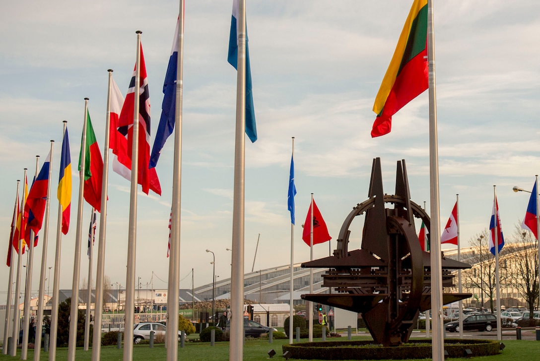 NATO country flags wave at the entrance of NATO headquarters in Brussels, Feb. 11, 2016. DoD photo by Air Force Senior Master Sgt. Adrian Cadiz