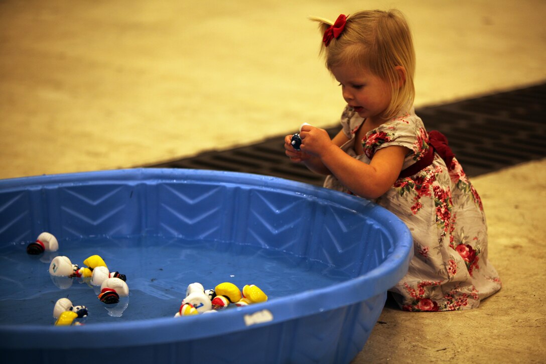 Scarlett M. looks at a rubber duck during the 7th annual Winter Wonderland at Marine Corps Air Station Cherry Point, N.C., Dec. 11, 2015. More than 700 Marines, Sailors and family members participate in the event. Winter Wonderland was hosted by Marine Aircraft Group 14 to foster camaraderie and increase esprit de corps within MAG-14 subordinate commands.