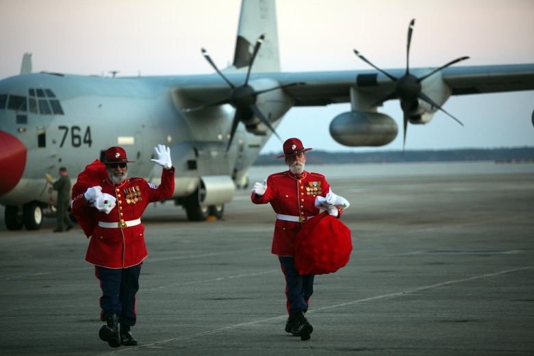 The Gunny Clauses' wave at Marines, Sailors and their family members during the 7th annual Winter Wonderland at Marine Corps Air Station Cherry Point, N.C., Dec. 11, 2015. The Clauses came from the North Pole on a KC-130J Super Hercules to deliver gifts to children with Marine Aircraft Group 14. More than 700 Marines, Sailors and family members participate in the event. Winter Wonderland was hosted by MAG-14 to foster camaraderie and increase esprit de corps within MAG-14 subordinate commands.