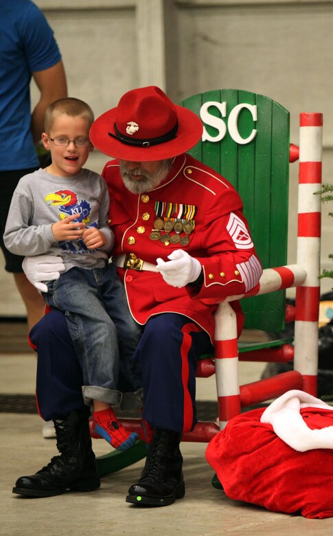 Garet H., tells Gunny Clause what he wants for Christmas during the 7th annual Winter Wonderland at Marine Corps Air Station Cherry Point, N.C., Dec. 11, 2015. More than 700 Marines, Sailors and family members participate in the event. Winter Wonderland was hosted by Marine Aircraft Group 14 to foster camaraderie and increase esprit de corps within MAG-14 subordinate commands.