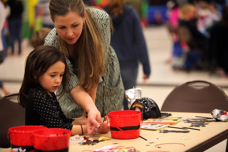 Michelle Moll and Ella M. decorate reindeers during the 7th annual Winter Wonderland at Marine Corps Air Station Cherry Point, N.C., Dec. 11, 2015. More than 700 Marines, Sailors and family members participate in the event. Winter Wonderland was hosted by Marine Aircraft Group 14 to foster camaraderie and increase esprit de corps within MAG-14 subordinate commands.