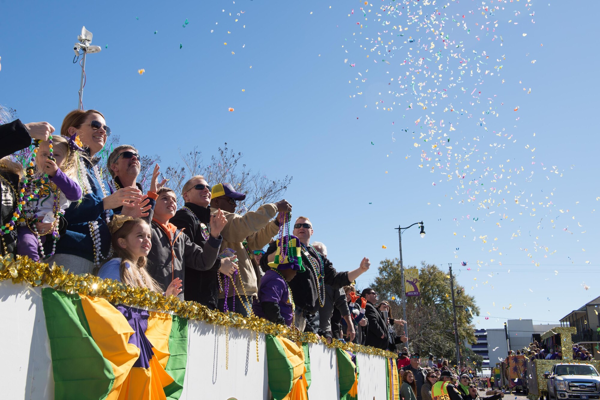 Col. Michele Edmondson, 81st Training Wing commander; her children, Jacqueline and Callahan, and her husband, Dave McGowan; and Col. Dennis Scarborough, 81st TRW vice commander; catch beads during the Gulf Coast Carnival Association Mardi Gras parade Feb. 9, 2016, Biloxi, Miss. The Keesler Honor Guard led the parade and other base leadership also attended the event. (U.S. Air Force photo by Marie Floyd) 