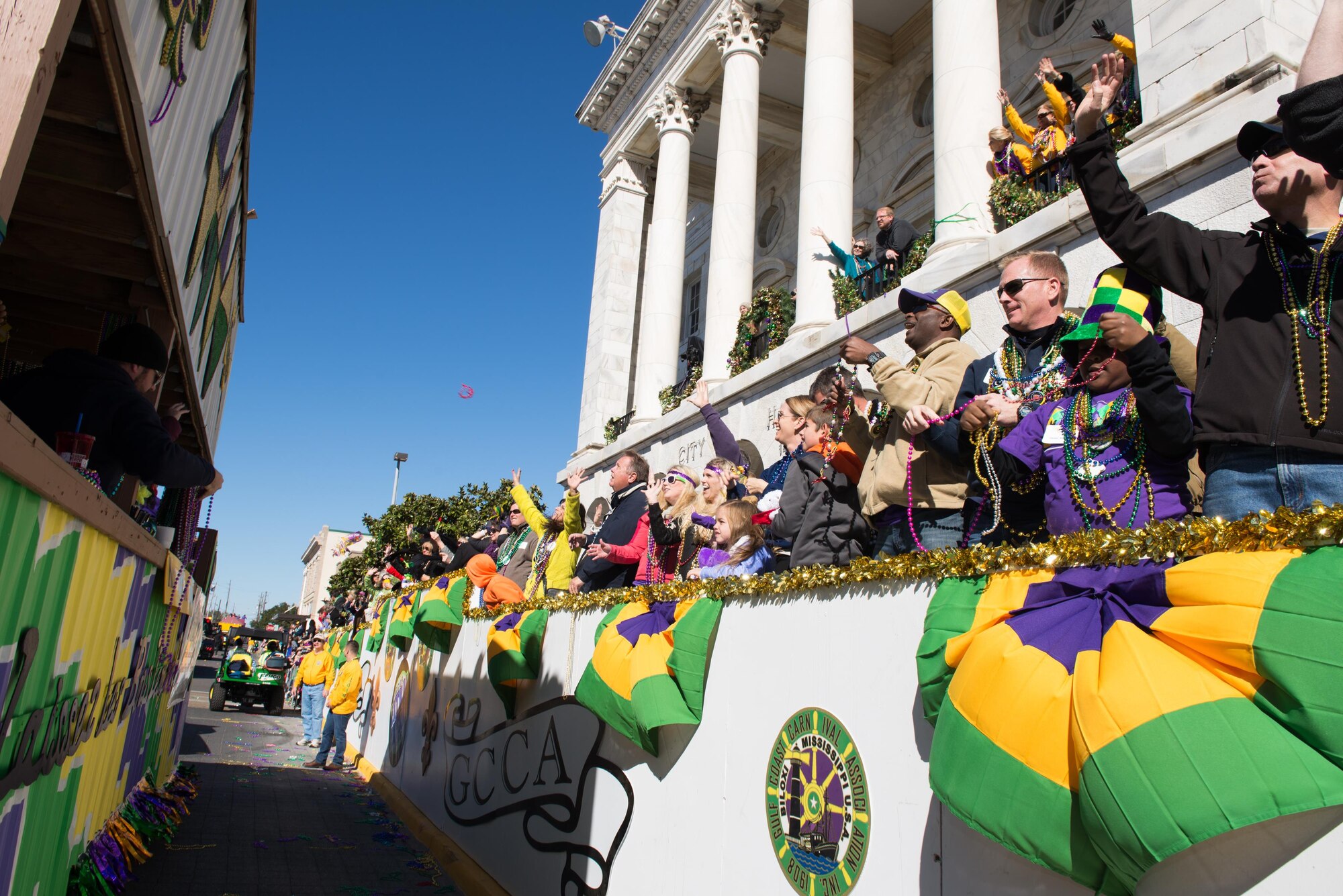 Col. Michele Edmondson, 81st Training Wing commander; her children, Jacqueline and Callahan, and her husband, Dave McGowan; and Col. Dennis Scarborough, 81st TRW vice commander; catch beads during the Gulf Coast Carnival Association Mardi Gras parade Feb. 9, 2016, Biloxi, Miss. The Keesler Honor Guard led the parade and other base leadership also attended the event. (U.S. Air Force photo by Marie Floyd) 