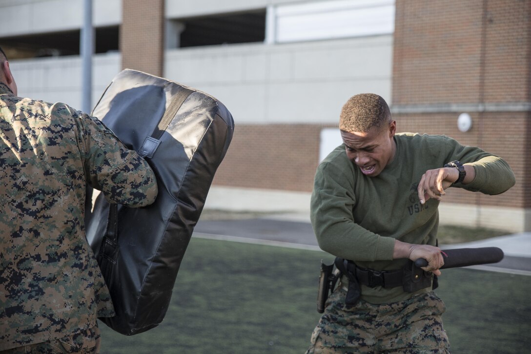 Pfc. Anthony Jones, a student with Class B-1, Guard Academy, conducts a series of striking techniques during an oleoresin capsicum spray practical application event at the Marine Barracks Washington, D.C., Annex Field, Feb. 11, 2016.(Official Marine Corps photo by Cpl. Chi Nguyen/Released)