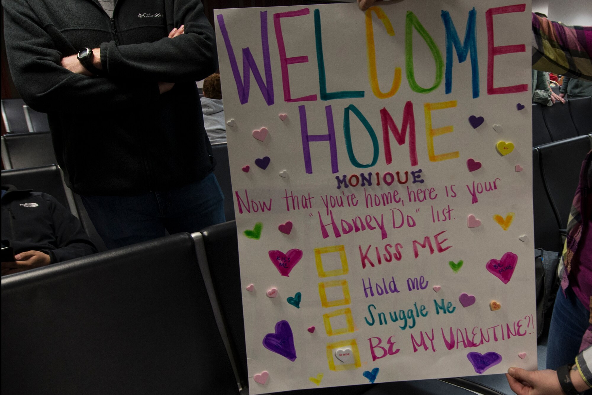 A loved one displays a ‘welcome home’ sign for an Airman from the 41st Rescue Squadron returning  from a deployment, Feb. 10, 2016, at Moody Air Force Base, Ga. Families and friends created signs, t-shirts, and other items to welcome their Airmen home. (U.S. Air Force photo by Airman 1st Class Janiqua P. Robinson/Released)