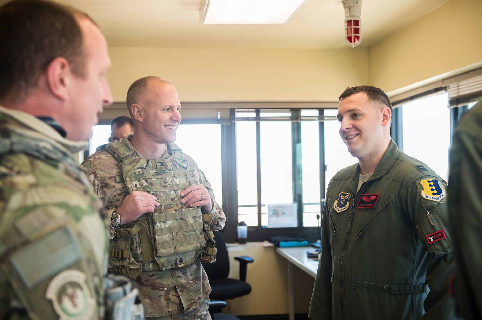 U.S. Air Force Capt. Anthony Bunker, 34th Bomb Squadron, shares a laugh with Col. Joseph Locke, 93d Air Ground Operations Wing commander, and Lt. Col. Steve Raspet, 7th Air Support Operations Squadron commander, Feb. 4, 2016, at the Oro Grande Training Complex at Fort Bliss, Texas. Locke had the opportunity to meet the Airmen and U.S. Army Soldiers participating in the exercise as well as the key leaders. (U.S. Air Force photo by Senior Airman Olivia Dominique/Released)